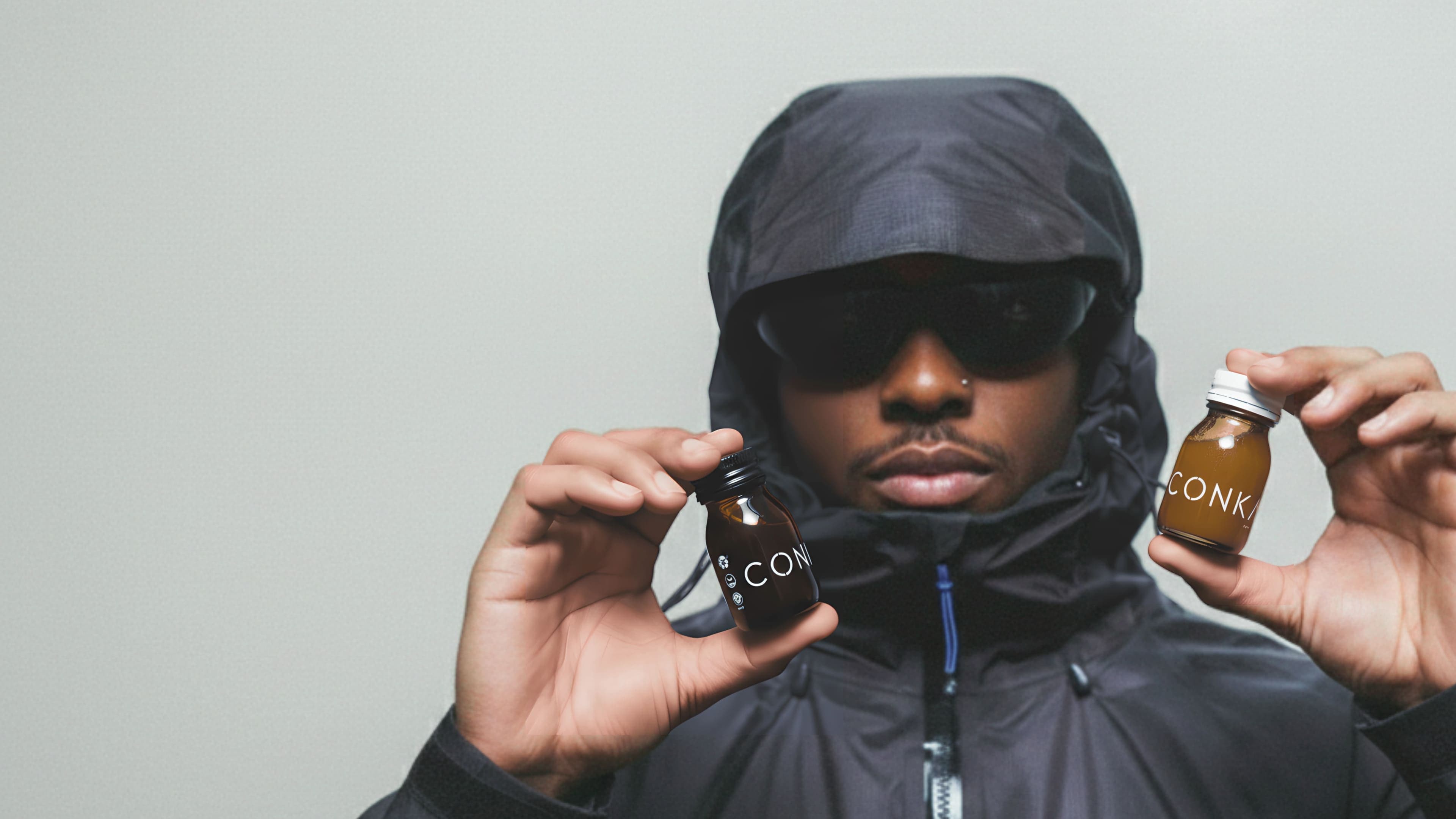 Athlete holding CONKA Flow and Clear bottles