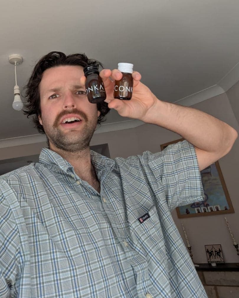 A CONKA customer holding the daily shots